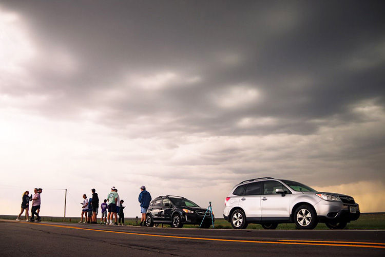 storm chase team under a big thunder cloud